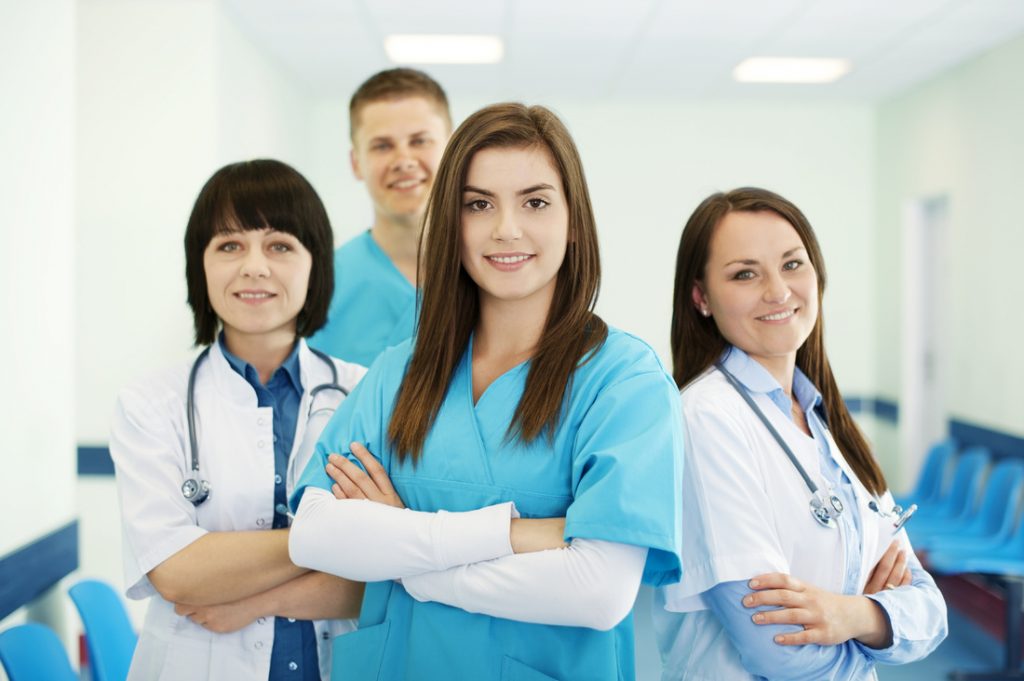 A group of people wearing scrubs